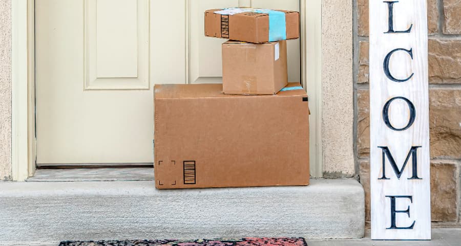 Boxes by the door of a residence with a welcome sign in Hagerstown